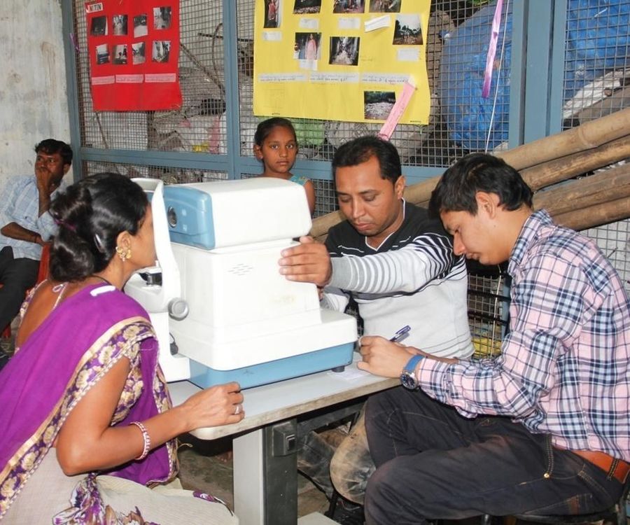 A woman has an eye test at a Gramshree medical camp